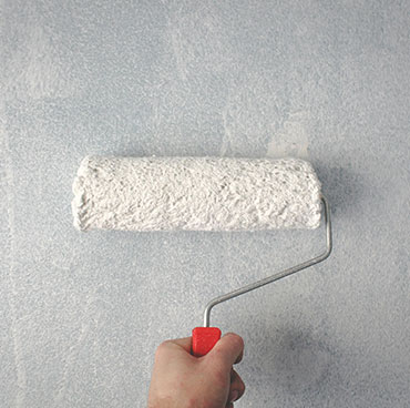 Paint roller on a wall for Interior & exterior painting in Oshawa